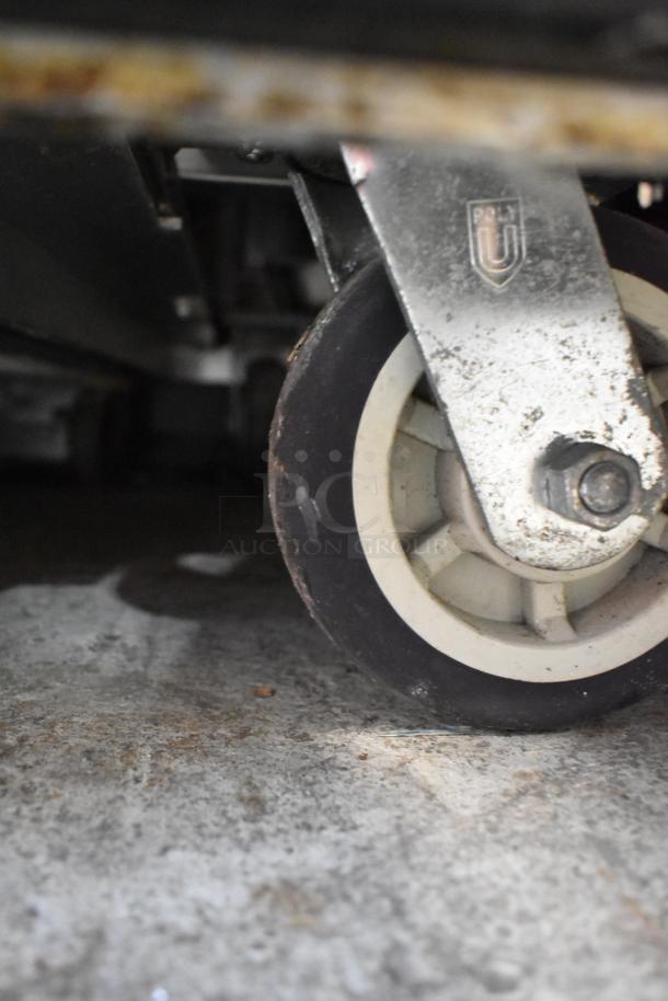 FWE SR-30 stainless steel warming cabinet on commercial caster. Features "Poly U" embossed mark. 120 volts, 1 phase.