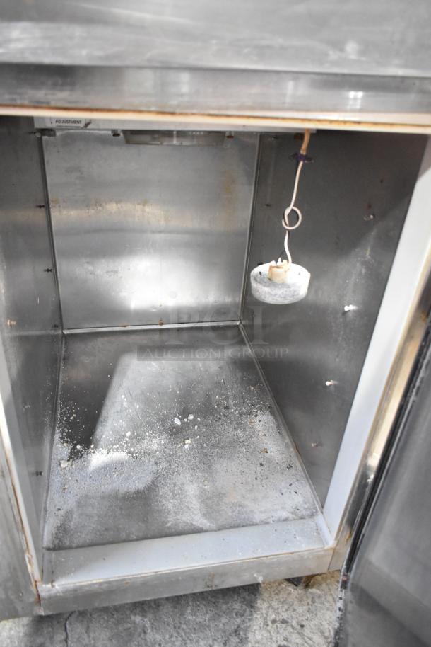 Continental 1RF-SS dual unit cooler and freezer interior, stainless steel, on casters, 115V, adjustable shelves, showing some wear.