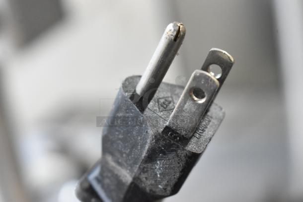 Close-up of a power plug from a 2016 Bunn TB3Q Stainless Steel Iced Tea Machine, showing slight wear, 120 Volts.