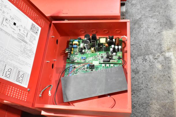 Red PowerPath Wheelock SP40S cabinet with exposed circuit board and wiring diagram. Includes labels with technical specifications.