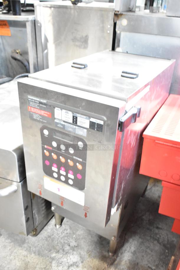Silver King stainless steel commercial dairy dispenser, countertop model, 115 volts, 1 phase, control panel visible, in used condition.