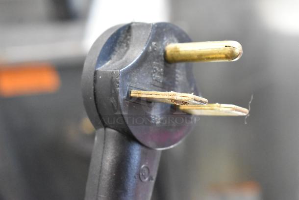 Close-up of a power plug for the 2019 Turbochef Encore 2 rapid cook oven, indicating 208/240V compatibility.