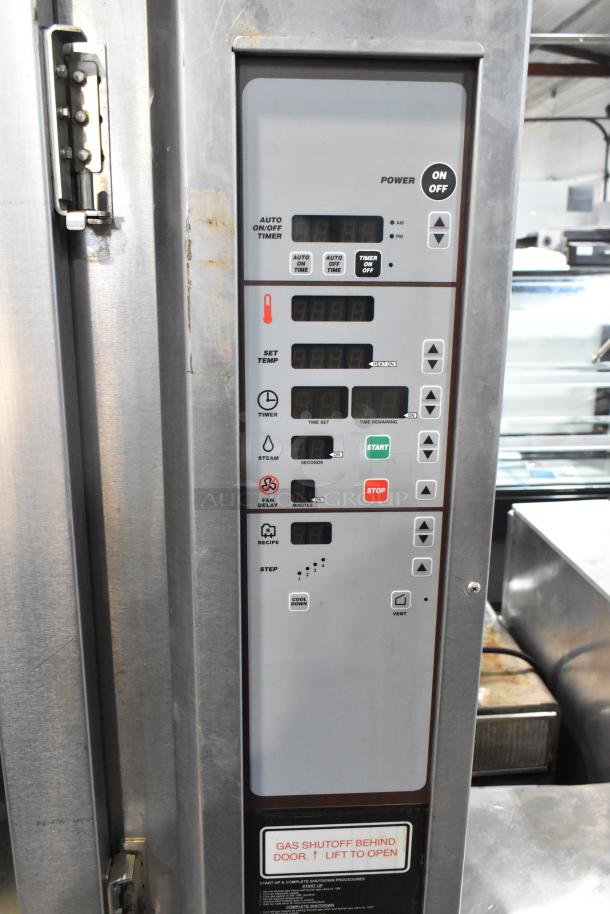 Baxter stainless steel commercial mini rotating rack oven control panel. Features include timers, temperature settings, and start/stop buttons. Gas shutoff label visible. 95,000 BTU.