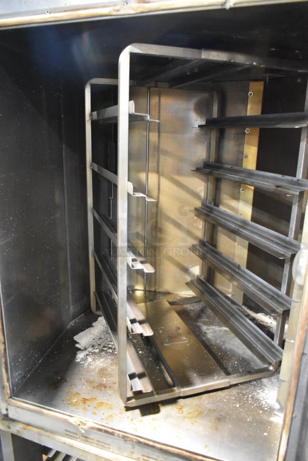 Baxter stainless steel rotating rack oven, natural gas, 95,000 BTU, double pan rack, commercial casters, used.