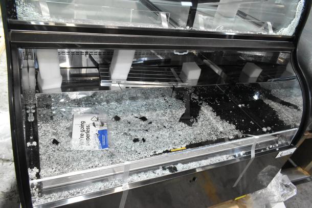 Avantco CAC-48 black refrigerated merchandiser; broken glass visible. 47 3/16" wide, 115 volts, 1 phase. Model 193CAC48B.