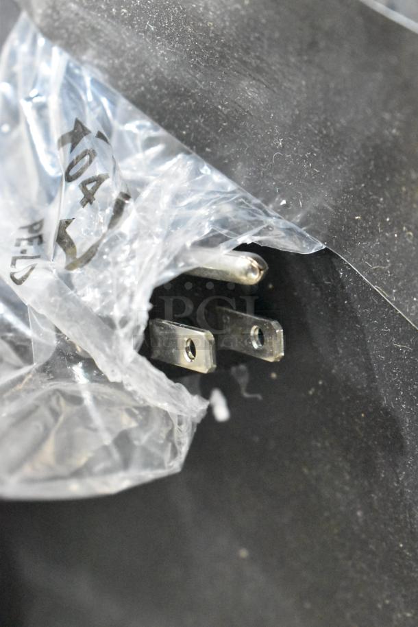 Close-up of plug on brand new Avantco OAM2A countertop merchandiser, revealing packaging and a scratch. 120 Volts, 1 Phase.