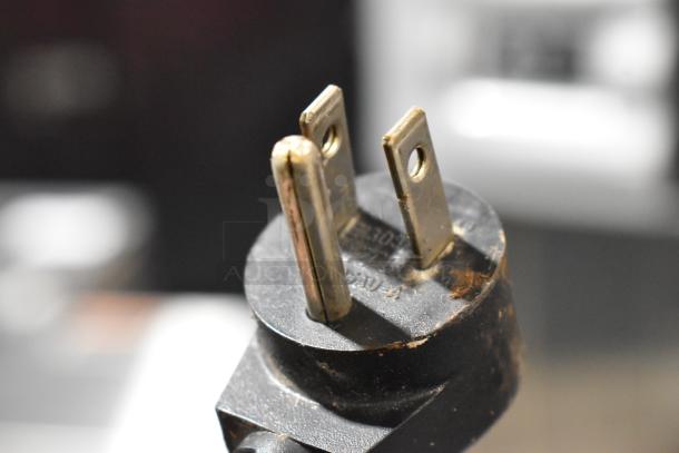 Close-up of a power plug for the Delfield 406CA-DD1 stainless steel undercounter cooler, 115 volts, 1 phase.