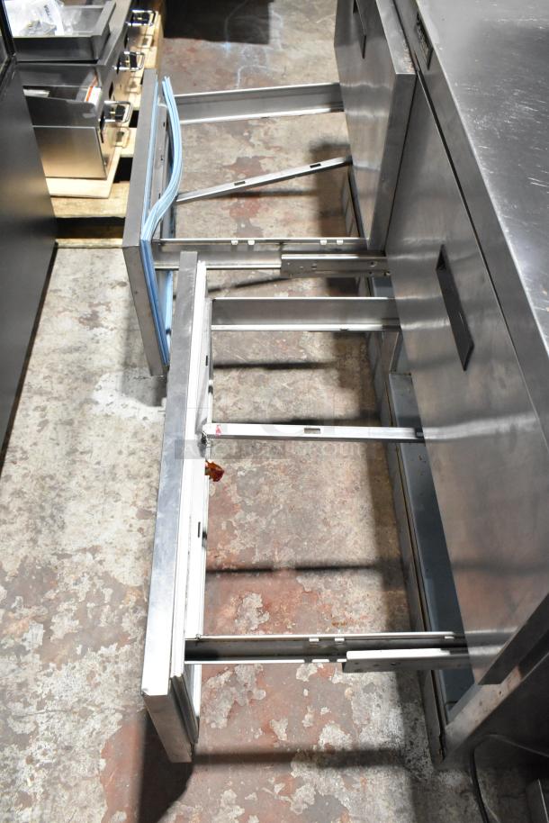 Delfield stainless steel sandwich salad prep table with 4 drawers open, mega top, and over-shelf. 115 volts, 1 phase. 