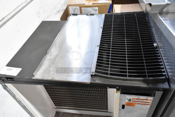 Manitowoc Stainless Steel Commercial Ice Head, used condition, with visible vents and safety labels.