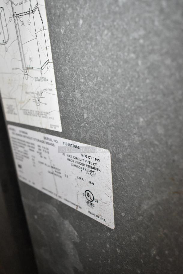 Manitowoc stainless steel commercial ice head, visible label with serial number, UL listed, made in USA.