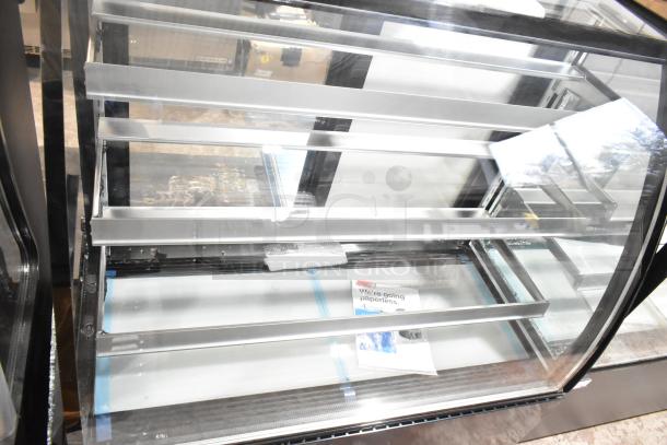 Brand new Avantco 193BCT48B curved glass bakery display case, 3 shelves, LED lighting, 49" black, minor scratches.