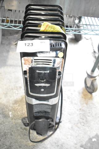 Honeywell KAZ HZ-709-WMT electric heater, black, 120 volts, front view with control panel and label visible.