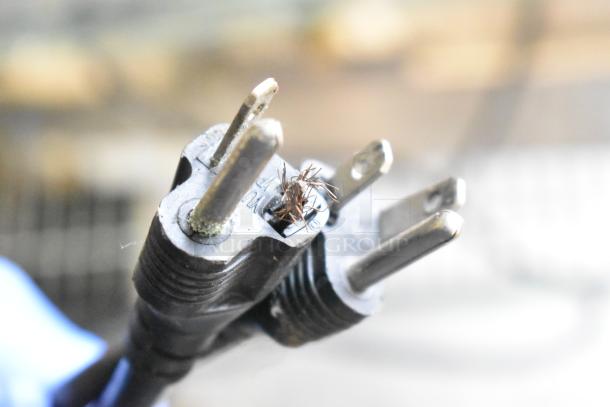Close-up of a damaged electrical plug on an ET-ZL2 fryer, showing exposed wires and corrosion, indicating need for repair.