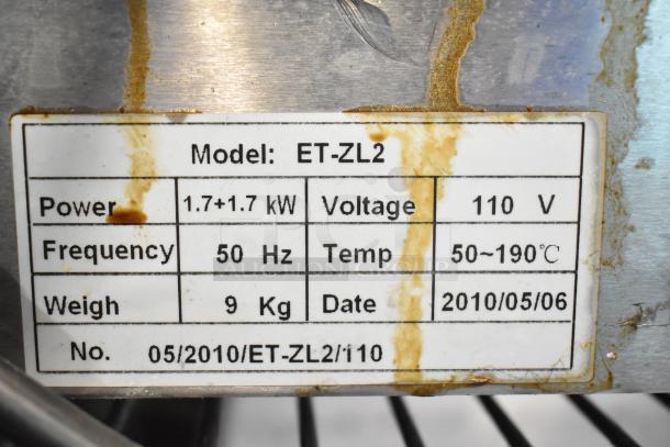 ET-ZL2 stainless steel electric 2-bay fryer, 110V, with metal lids. Model tag shows power, voltage, and production date.