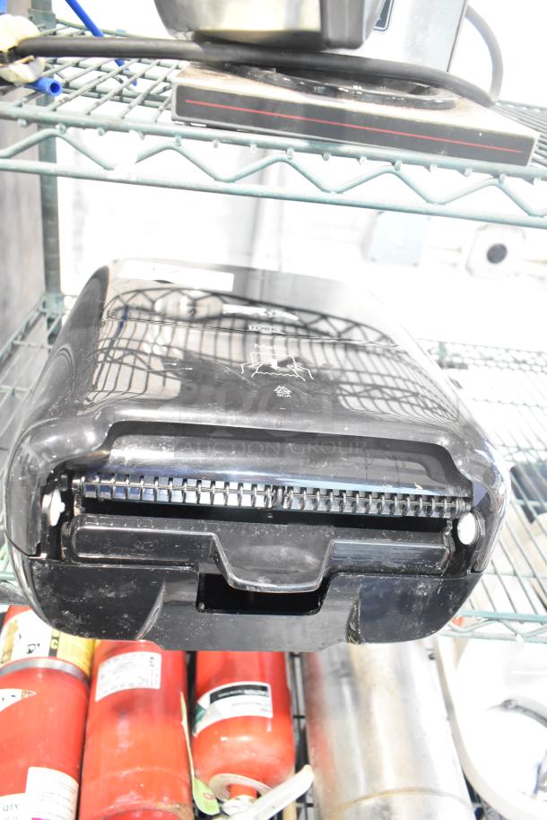 Tork Black Poly Wall Mount Paper Towel Dispenser, sleek design, moderate wear, easy access, ideal for commercial use.