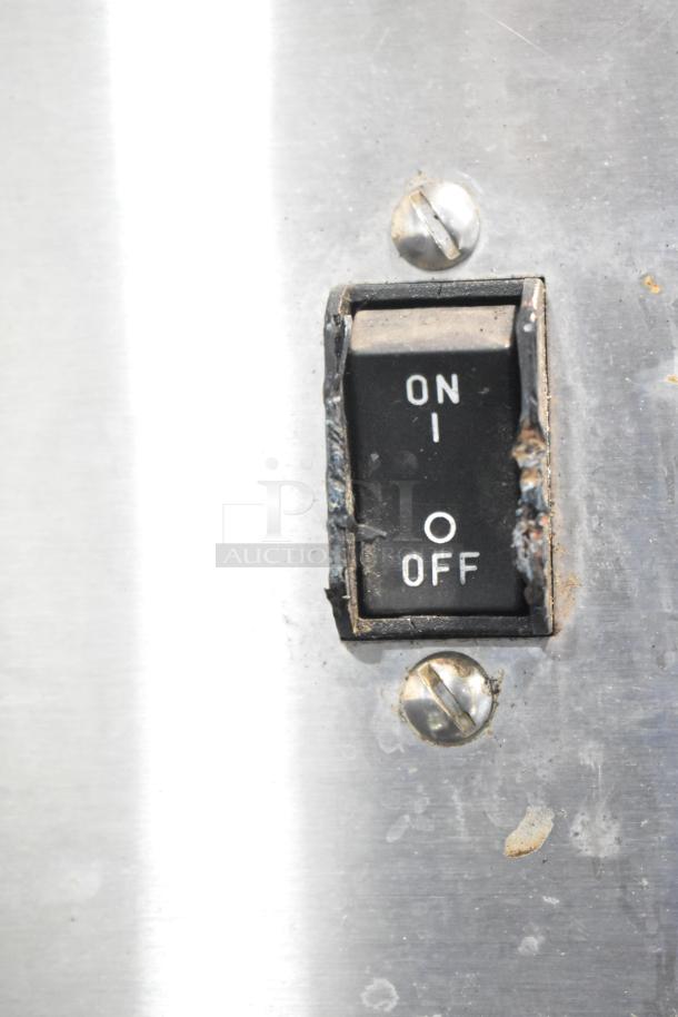 Close-up of an "ON/OFF" switch on a Bunn CDBCFP20 coffee machine, showing wear and stainless steel surface.