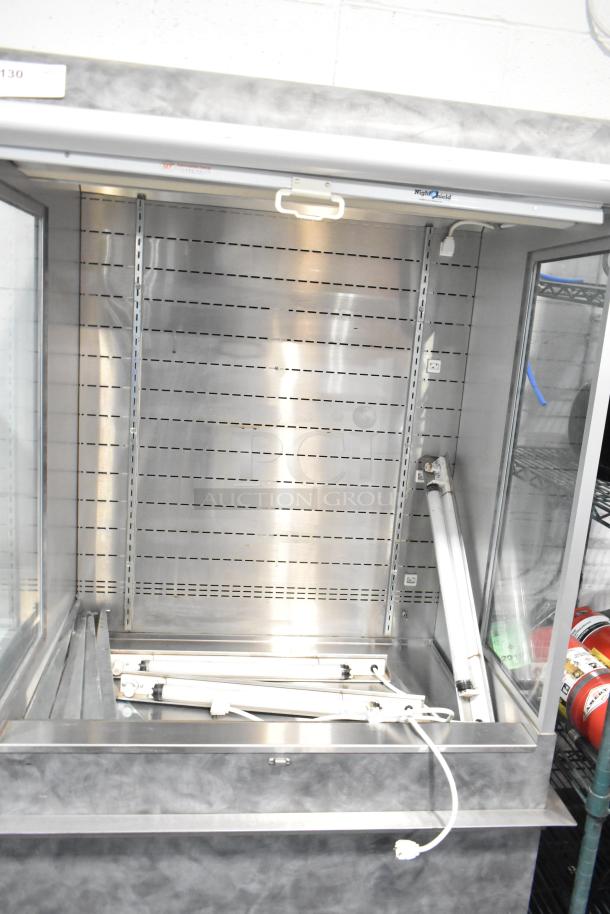 Metal commercial vertical reach-in grab n go merchandiser, 115 volts, 1 phase, clean condition, shelves removed, open door.
