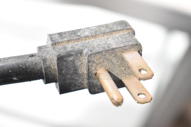 Plug of a metal commercial vertical reach-in grab-n-go merchandiser, 115 volts, 1 phase, dusty condition.