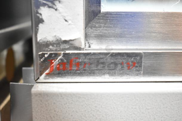Jahabow metal display case with visible wear. Features a visible "Jahabow" logo tag on metal frame, made for commercial use.