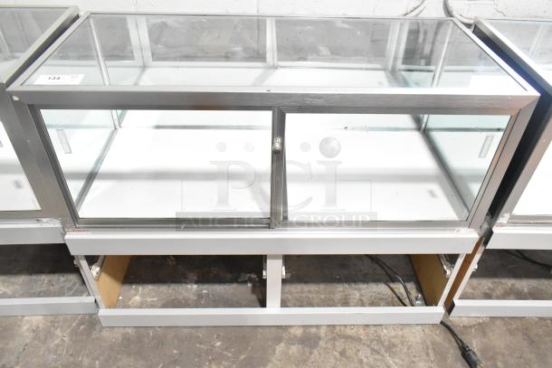Jahabow metal commercial dry merchandise display case, glass panels, sliding doors, good condition, ideal for retail.