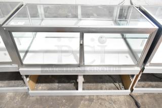 Jahabow metal commercial dry merchandise display case, glass panels, sliding doors, good condition, ideal for retail.
