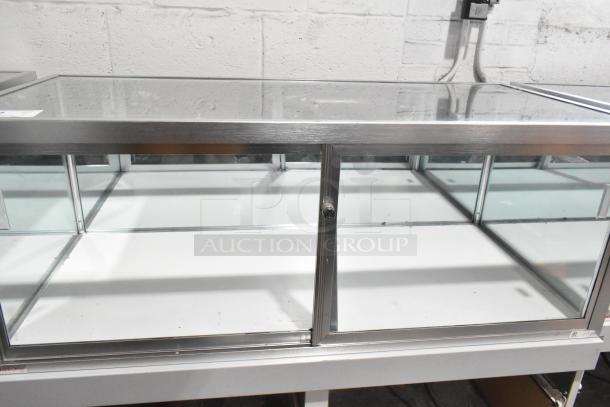 Jahabow metal commercial dry merchandise display case with glass panels and sliding doors. Excellent condition.