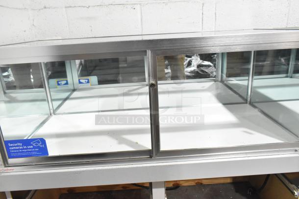 Jahabow metal commercial dry merchandise display case, glass front, security label visible, clean condition.