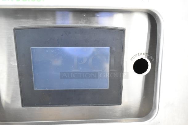 Stainless steel commercial citrus juicer, JBT 2ND-GEN-MFJ-HE, touchscreen interface, power option, on casters.