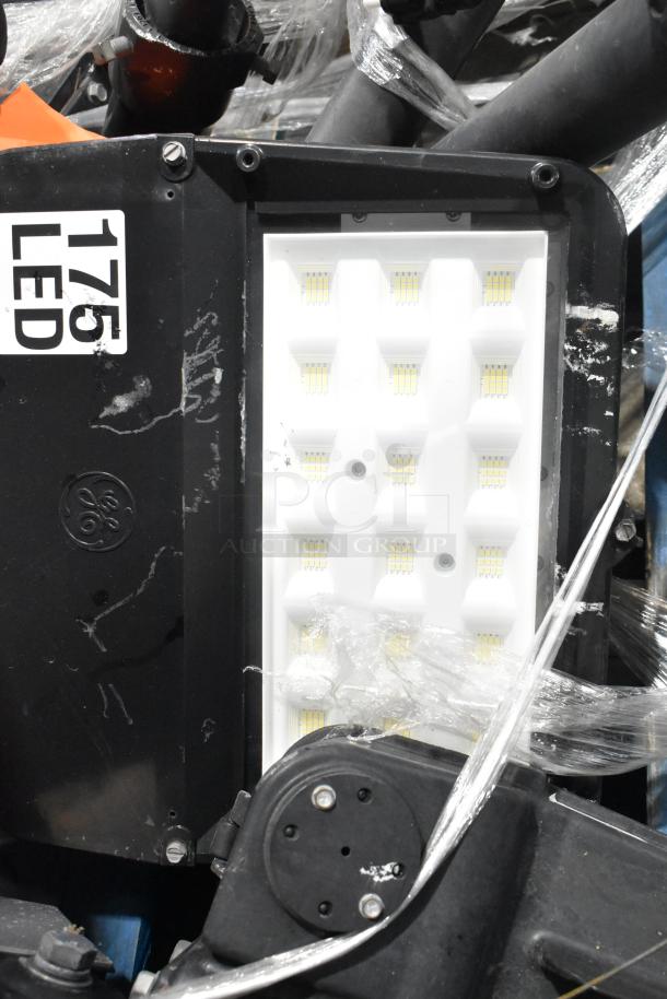 5 metal outdoor light fixtures, various styles, featuring LED panels. Visible "175 LED" label. Slightly worn condition.