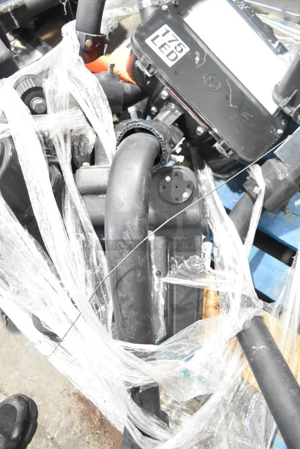 Five metal outdoor light fixtures, wrapped in plastic. Includes LED lights, label shows "175 LED." Good condition.