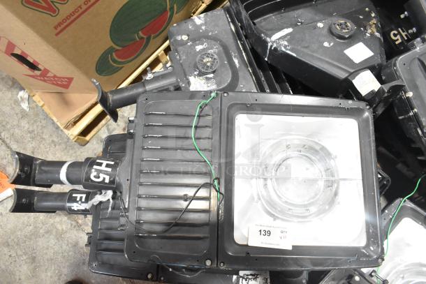 11 metal outdoor light fixtures, including General Electric. Mixed condition, visible wiring, model tags H5 and F4.