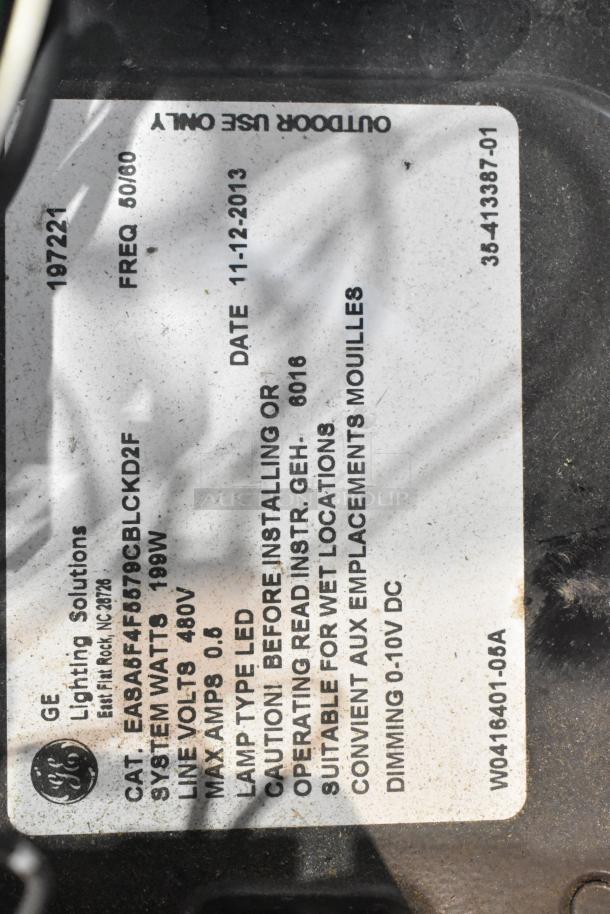 GE outdoor lighting fixture label showing model EASAFAF5679CBLKD2F, 199W, 480V, LED, suitable for wet locations.