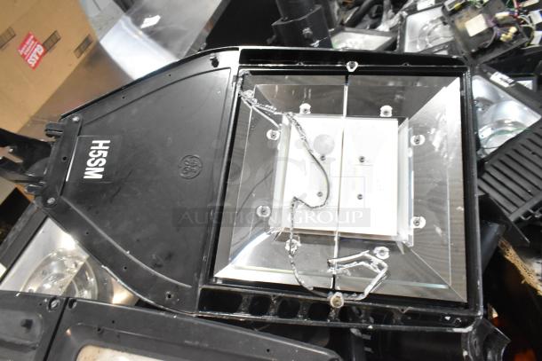 16 various metal outdoor light fixtures, including General Electric GE model, in used condition, with visible wiring and mounts.