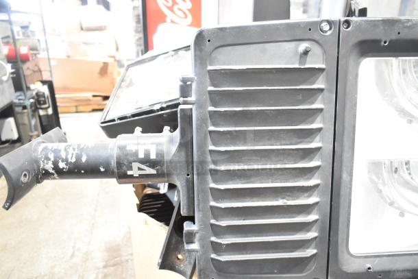 16 mixed metal outdoor light fixtures, including General Electric GE, in used condition with visible paint wear and "F4" marking.