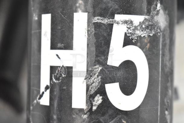 16 metal outdoor light fixtures, including General Electric, mixed conditions. Close-up shows possible wear on surface.