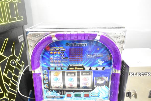 Olympia Excellence Metal Ice Story slot machine, featuring a vibrant purple frame, digital display, and themed graphics.