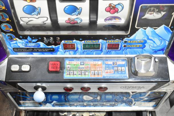 Olympia Excellence Metal Ice Story Slot Machine, features colorful graphics and digital displays, buttons labeled Insert, Cancel, Bet, Max Bet.