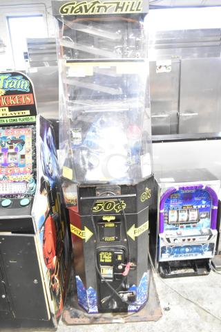 Gravity Hill metal floor style arcade game, featuring coin slot, prize compartment, and vibrant graphics, fair condition.