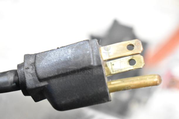 Close-up of a three-prong plug for the Big Haul Metal Floor Style Arcade Game, 120V, 1 Phase, in good condition.