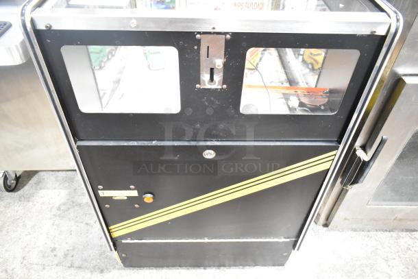 Big Haul Metal Floor Style Arcade Game, black with yellow stripes, coin slot, 120 Volts, 1 Phase, good condition.