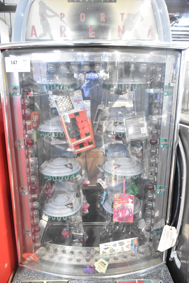 Sports Arena metal floor-style arcade game, showcasing prizes inside. Powered at 120 volts, 1 phase. Good condition.
