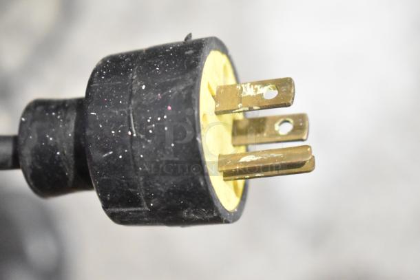 Close-up of a black power plug for a Sports Arena Metal Floor Style Arcade Game, 120 volts, 1 phase.