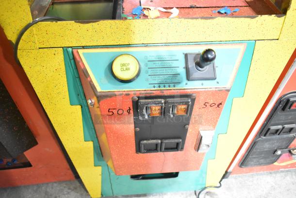 The Challenger metal floor style claw machine game, 120 volts, 1 phase, vibrant yellow, joystick and drop claw button, 50¢ label.