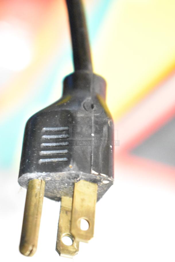 Close-up of a power plug for The Challenger Claw Machine Game, showing a 120-volt, 1-phase connection.