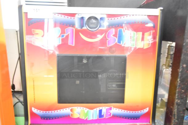 Smile Metal Floor Style Photo Machine, vibrant design, 120 volts, 1 phase, camera lens on top, good condition, ideal for events.