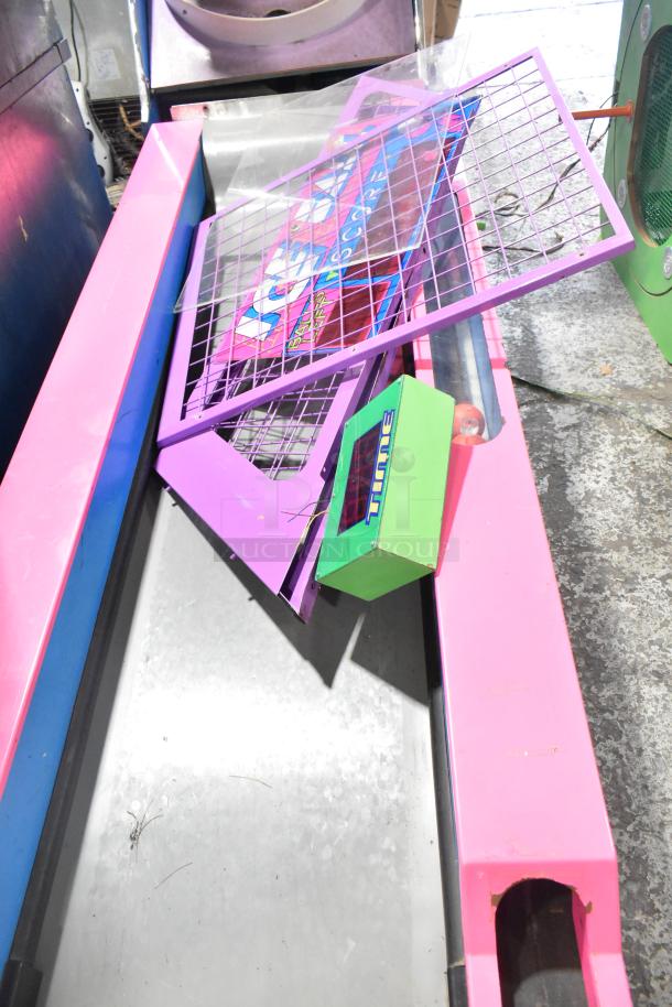 Ice Ball Metal Floor Style Skee Ball Machine, pink frame, visible panel damage. 120 volts, 1 phase power, parts scattered.