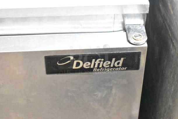 Delfield 406CA-DD1 stainless steel undercounter cooler, single door, 115 volts, 1 phase, Delfield label visible.