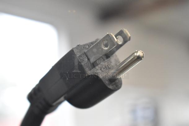 Close-up image of a black electrical plug for the Avantco 189BVAC46HC Commercial Refrigerated Air Curtain Merchandiser.