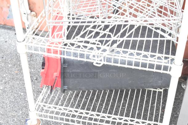 Tan 3-tier wire shelving unit with commercial casters, includes 2 extra shelves, in used condition. Buyer must dismantle.