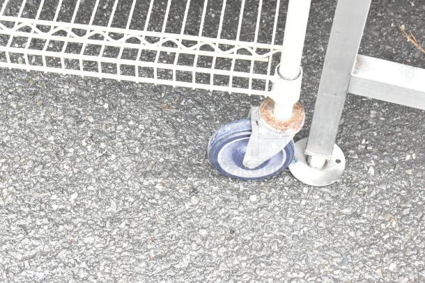 Tan 3-tier wire shelving unit with commercial casters, includes 2 extra shelves. Buyer must dismantle. Consider freight charges.